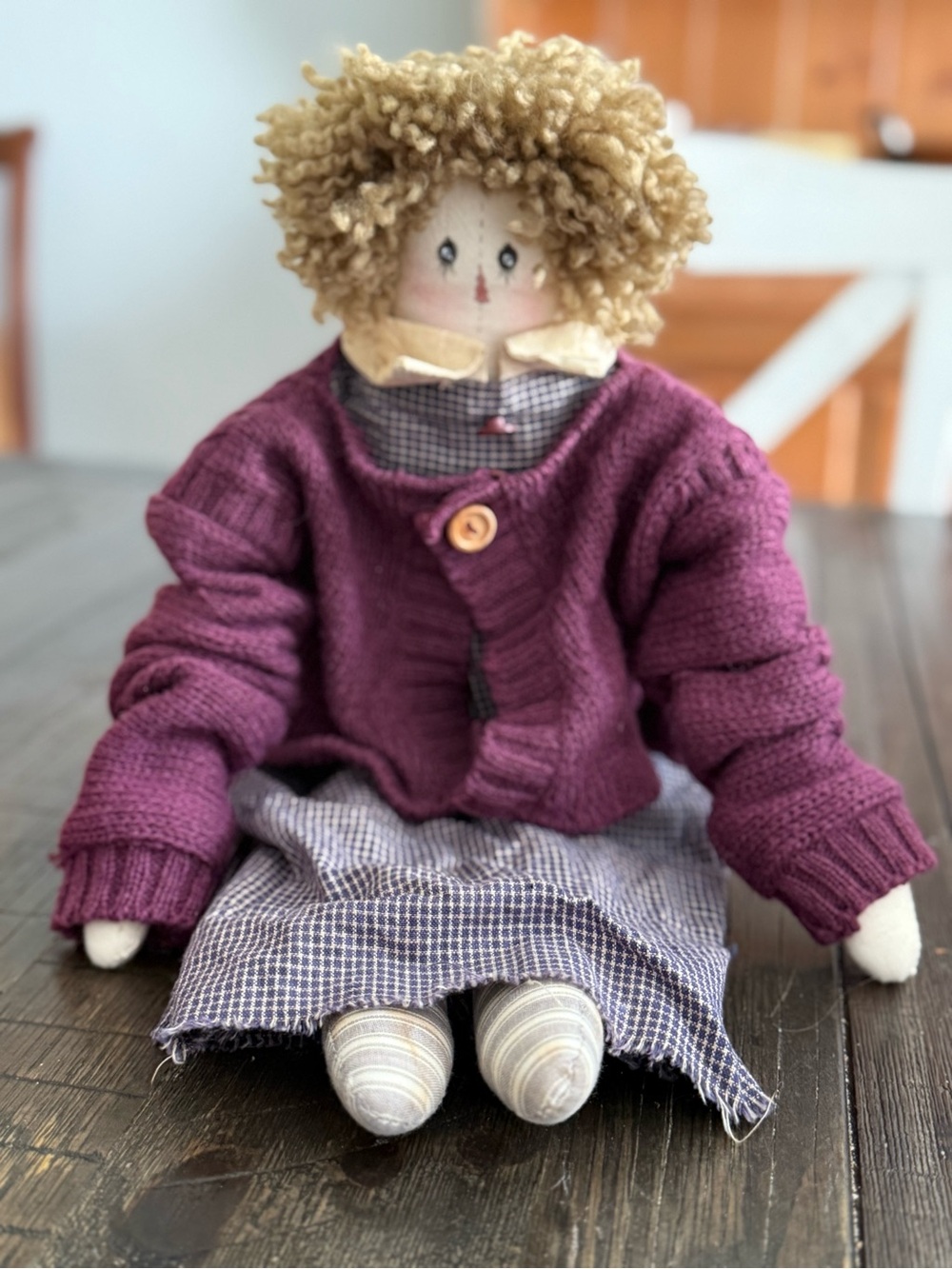 A handmade primitive-style cloth rag doll.